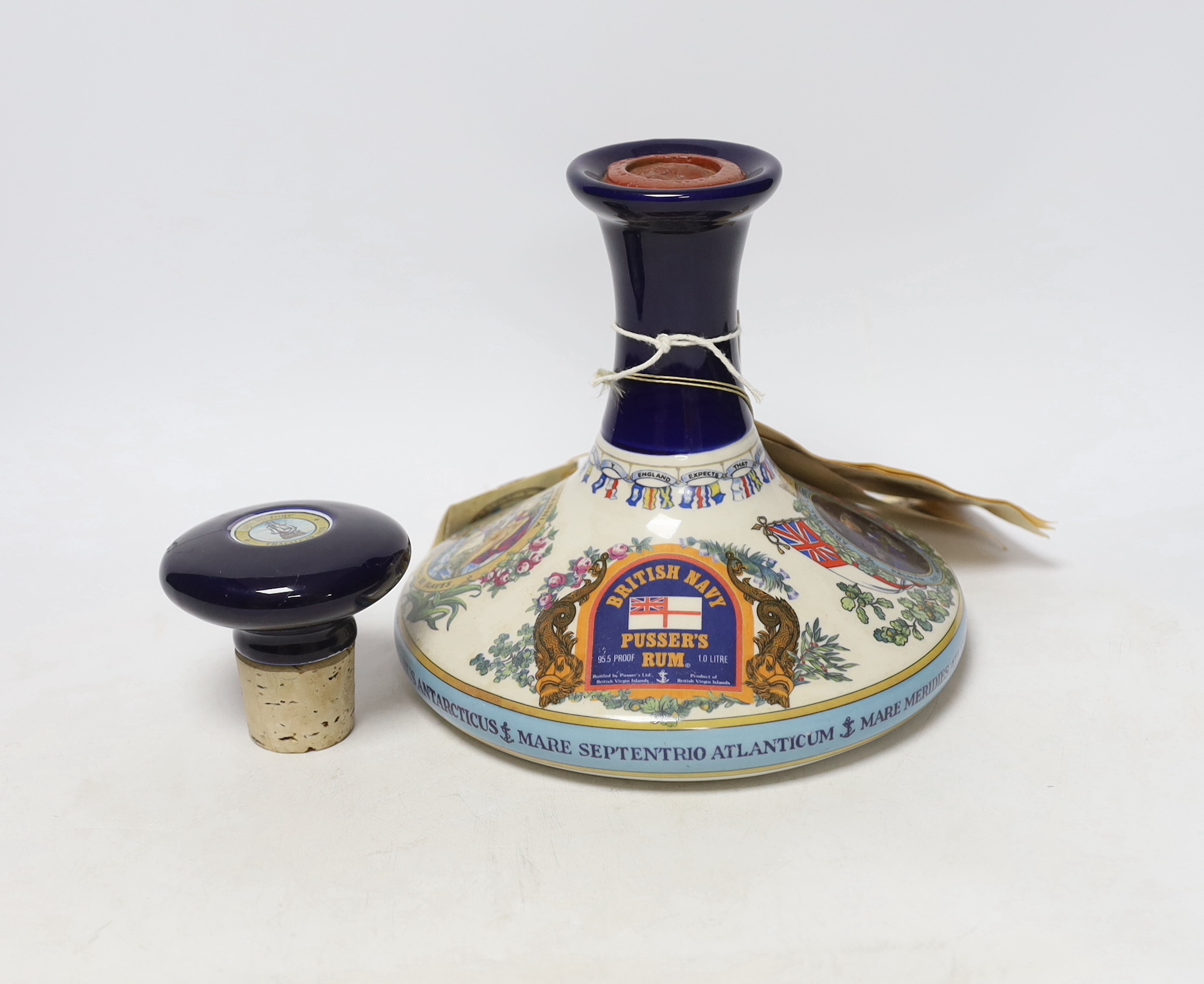 A commemorative ceramic decanter for HMS victory at the Battle of Trafalgar 1805, containing British Navy Pusser’s Rum, with separate stopper, decanter 18.5cm high